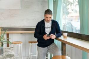 Sales professional on a phone call at an office desk, by IDEAIFY Solutions