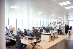 Team working at desks in a busy open office, representing Q1 outsourcing surge staffing, by IDEAIFY Solutions
